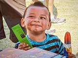 A popsicle and a bookmark made this youngster happy. © Denise Gary