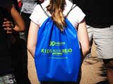 Kids who donated books left with a Kids Need to Read goodie backpack, sponsored by Bookmans. © Denise Gary