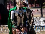 Loki poses with a young fan. © Bruce Matsunaga