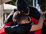 Denise receives a hug from Red Robin. © Bruce Matsunaga