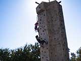 Kids enjoy a rock climbing wall. © Robert Gary