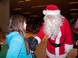 They were then greeted by Santa, who gave them holiday sweets. © Denise Gary