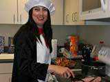 Principal Elizabeth Gonzalez dressed the part and fried the ham. © Denise Gary