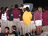 Students gather to interact with the author after the presentation. © Robert Gary