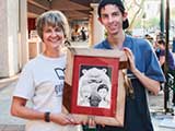 Denise and Robert had their Yosemite bear encounter artwork, drawn by author/illustrator Steven Riley, framed at a Second Friday booth. © Robert Gary