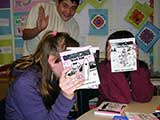 Two shy <em>Babymouse</em> fans hide, while a not so shy student waves. © Katherine Roddy