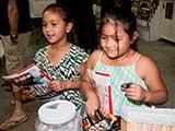 Kids received buttons, bookmarks, and Highlights magazines at the KNTR table. © Denise Gary