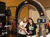 KNTR volunteers Alicia Summers and Sherrie Miller have fun under the KNTR Geek Arch. © Bruce Matsunaga