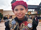 A boy decks his costume out with KNTR buttons!