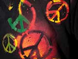 Colorful peace symbols decorate a teen's t-shirt. © Denise Gary