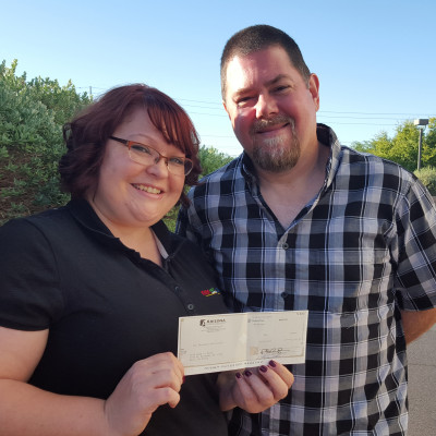 KNTR Operations Director Lori Cothrun and Board Member Gary Mlodzik accept grant funds on behalf of Kids Need to Read at the Cox Charities award breakfast.